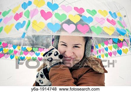 Young girl outside in a park holding umbrella View Large Photo Image Stock Photo - Young girl outside in a park holding umbrella. Fotosearch
