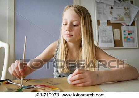Young girl painting easter eggs View Large Photo Image Stock Image - Young girl painting easter eggs. Fotosearch