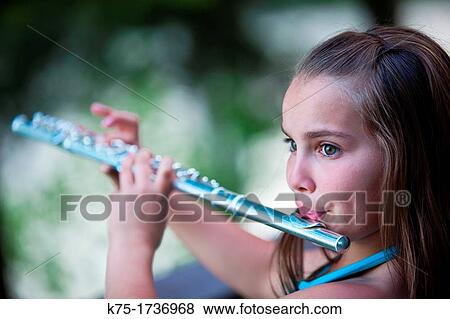 young girl playing flute View Large Photo Image Stock Photo - young girl playing flute. Fotosearch