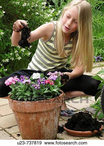 Stock Photo - Young girl playing in the garden.. Fotosearch