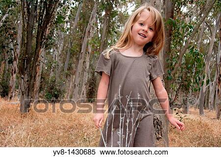 Young girl playing in the woods View Large Photo Image Stock Photography - Young girl playing in the woods. Fotosearch