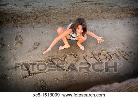 Young girl playing on the beach View Large Photo Image Stock Photo - Young girl playing on the beach. Fotosearch