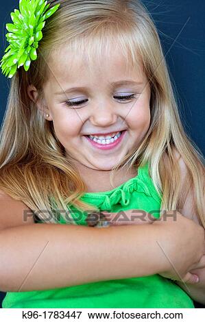 Stock Photo - Young girl playing with a snail. Fotosearch