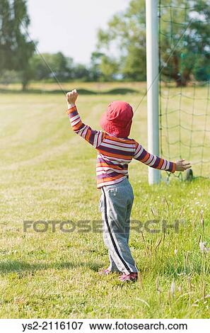 Young girl playing with net of football (soccer) goal. View Large Photo Image Stock Photo - Young girl playing with net of football (soccer) goal.. Fotosearch