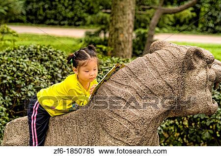 Young girl portrait on stone statue of Tiger at Shanghai Zoo in Shanghai China. View Large Photo Image Stock Photography - Young girl portrait on stone statue of Tiger at Shanghai Zoo in Shanghai China.. Fotosearch