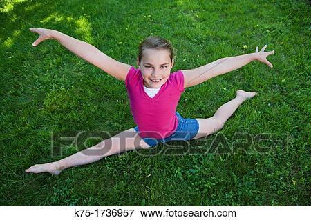 young girl practicing a gymnastic routine View Large Photo Image Stock Photo - young girl practicing a gymnastic routine. Fotosearch