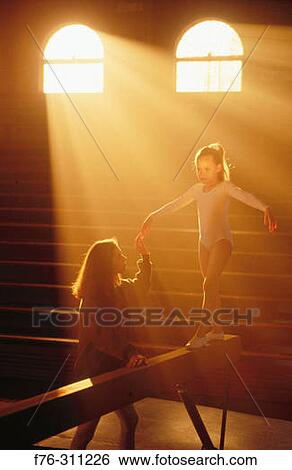 Young girl practicing on balance beam. View Large Photo Image Stock Photograph - Young girl practicing on balance beam.. Fotosearch