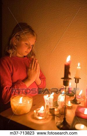 Stock Image - Young girl praying. Fotosearch
