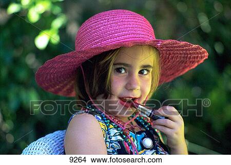 Young girl putting on make-up View Large Photo Image Picture - Young girl putting on make-up. Fotosearch