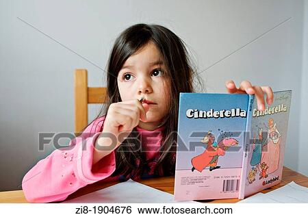 Young girl reading a book View Large Photo Image Stock Photograph - Young girl reading a book. Fotosearch