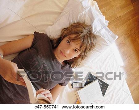 Stock Image - Young girl reading. Fotosearch