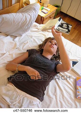 Stock Photograph - Young girl reading the Diary of Anne Frank. Fotosearch