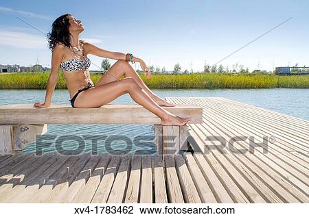 Young girl relaxed with bikini at lake in summertime View Large Photo Image Stock Image - Young girl relaxed with bikini at lake in summertime. Fotosearch
