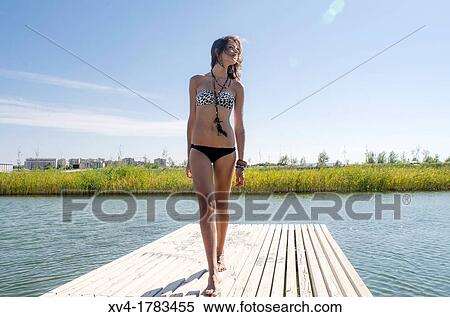 Young girl relaxed with bikini at lake in summertime View Large Photo Image Stock Photography - Young girl relaxed with bikini at lake in summertime. Fotosearch