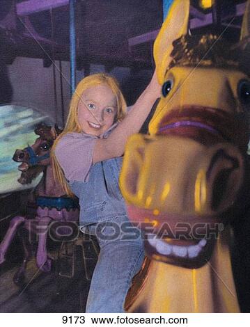 Young girl rides carousel View Large Photo Image Stock Image - Young girl rides carousel. Fotosearch