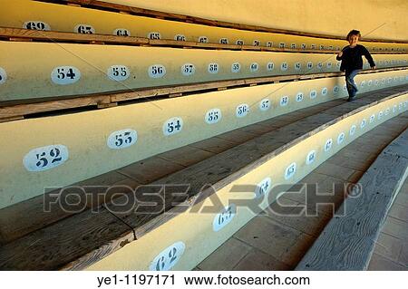 Young girl running along the empty benches of a bullring arena, Ronda, Spain. View Large Photo Image Stock Image - Young girl running along the empty benches of a bullring arena, Ronda, Spain.. Fotosearch