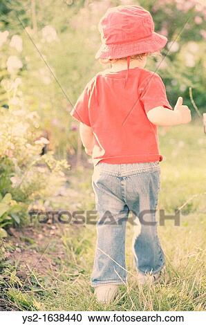 Young girl running in a garden View Large Photo Image Stock Image - Young girl running in a garden. Fotosearch