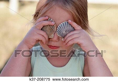 Stock Photography - Young girl shell collector. Fotosearch