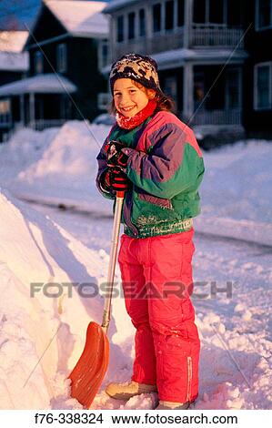 Picture - Young girl shovelling snow. Fotosearch