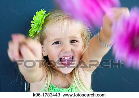 young girl showing flowers to camera View Large Photo Image Stock Image - young girl showing flowers to camera. Fotosearch