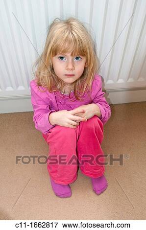 young girl sitting on floor looking worried View Large Photo Image Stock Photo - young girl sitting on floor looking worried. Fotosearch