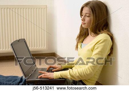 Young girl sitting on floor with laptop computer View Large Photo Image Stock Image - Young girl sitting on floor with laptop computer. Fotosearch