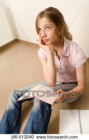 Young girl sitting on floor, writing in book View Large Photo Image Stock Image - Young girl sitting on floor, writing in book. Fotosearch