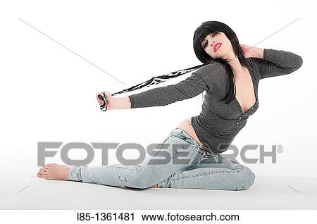 Young girl sitting on the floor View Large Photo Image Stock Image - Young girl sitting on the floor. Fotosearch