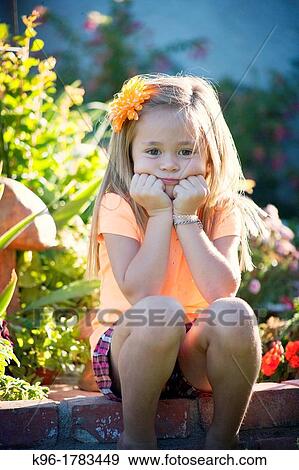 young girl sitting outside in sunlight View Large Photo Image Stock Photo - young girl sitting outside in sunlight. Fotosearch