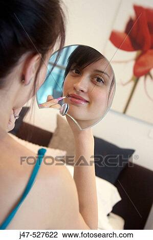 young girl sitting with mirror and make-up brush smiling into camera View Large Photo Image Stock Image - young girl sitting with mirror and make-up brush smiling into camera. Fotosearch