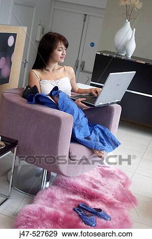 young girl sitting working on a laptop View Large Photo Image Stock Photo - young girl sitting working on a laptop. Fotosearch