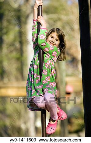 Young girl sliding on pole at playground - Franklin Park - Brevard, North Carolina View Large Photo Image Stock Photo - Young girl sliding on pole at playground - Franklin Park - Brevard, North Carolina. Fotosearch