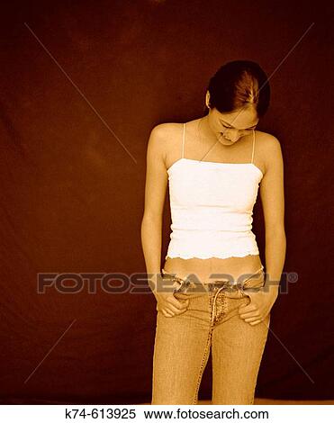 Young girl smiling, looking down View Large Photo Image Stock Photography - Young girl smiling, looking down. Fotosearch