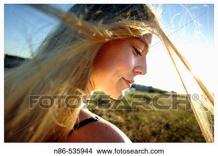 Young girl smiling playing with her hair View Large Photo Image Picture - Young girl smiling playing with her hair. Fotosearch