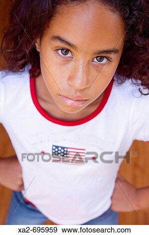 Young girl standing with hands on hips View Large Photo Image Stock Photo - Young girl standing with hands on hips. Fotosearch