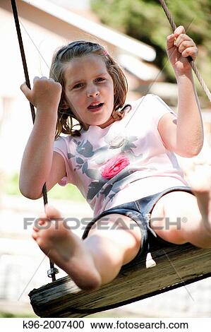 young girl swinging View Large Photo Image Stock Image - young girl swinging. Fotosearch