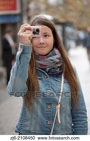 Young girl taking photos in the street of Prague. View Large Photo Image Stock Image - Young girl taking photos in the street of Prague.. Fotosearch