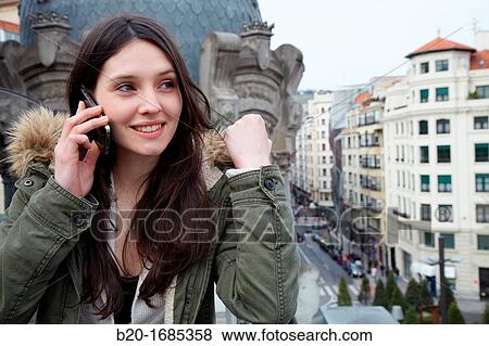 Young girl talking on mobile phone, Urban terrace bar, Alhondiga building, leisure and culture center, Bilbao, Bizkaia, Basque Country, Spain View Large Photo Image Stock Photo - Young girl talking on mobile phone, Urban terrace bar, Alhondiga building, leisure and culture center, Bilbao, Bizkaia, Basque Country, Spain. Fotosearch