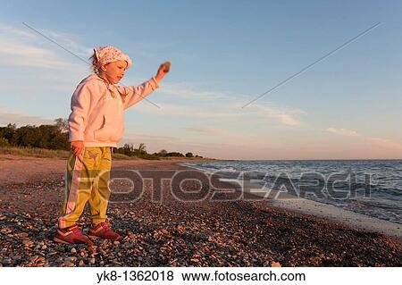 Young Girl Throwing Stone into Water View Large Photo Image Stock Photo - Young Girl Throwing Stone into Water. Fotosearch