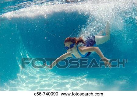Stock Image - Young girl underwater. Fotosearch