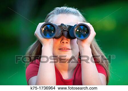 Picture - Young girl using binoculars. Fotosearch