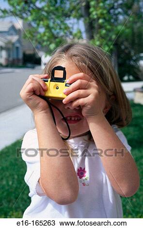 Young girl using her camera View Large Photo Image Stock Image - Young girl using her camera. Fotosearch