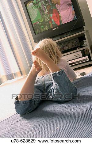 Young girl watching television View Large Photo Image Stock Photo - Young girl watching television. Fotosearch