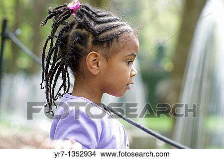Picture - Young girl watching water fountain. Fotosearch