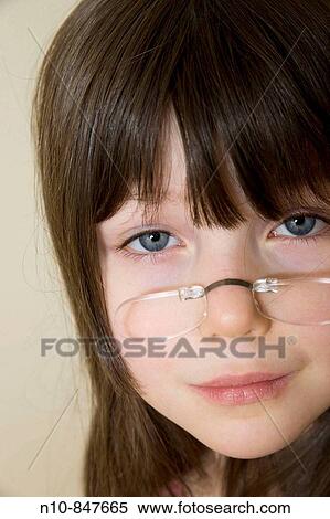 Young girl wearing glasses that attach directly to her nose. View Large Photo Image Stock Photography - Young girl wearing glasses that attach directly to her nose.. Fotosearch