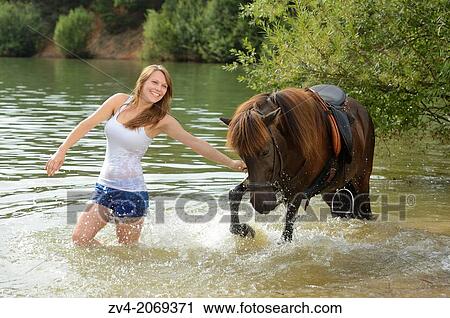 Young girl with an brown icelandic horse in summer, Bavaria, Germany. View Large Photo Image Stock Image - Young girl with an brown icelandic horse in summer, Bavaria, Germany.. Fotosearch