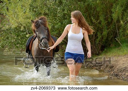 Young girl with an brown icelandic horse in summer, Bavaria, Germany. View Large Photo Image Stock Image - Young girl with an brown icelandic horse in summer, Bavaria, Germany.. Fotosearch