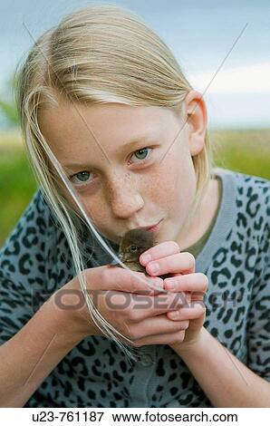 Young girl with baby duck in her hands. View Large Photo Image Stock Photo - Young girl with baby duck in her hands.. Fotosearch