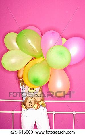 Stock Image - Young girl with balloons. Fotosearch