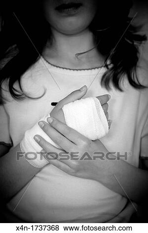 Stock Photo - Young girl with bandaged hand. Fotosearch